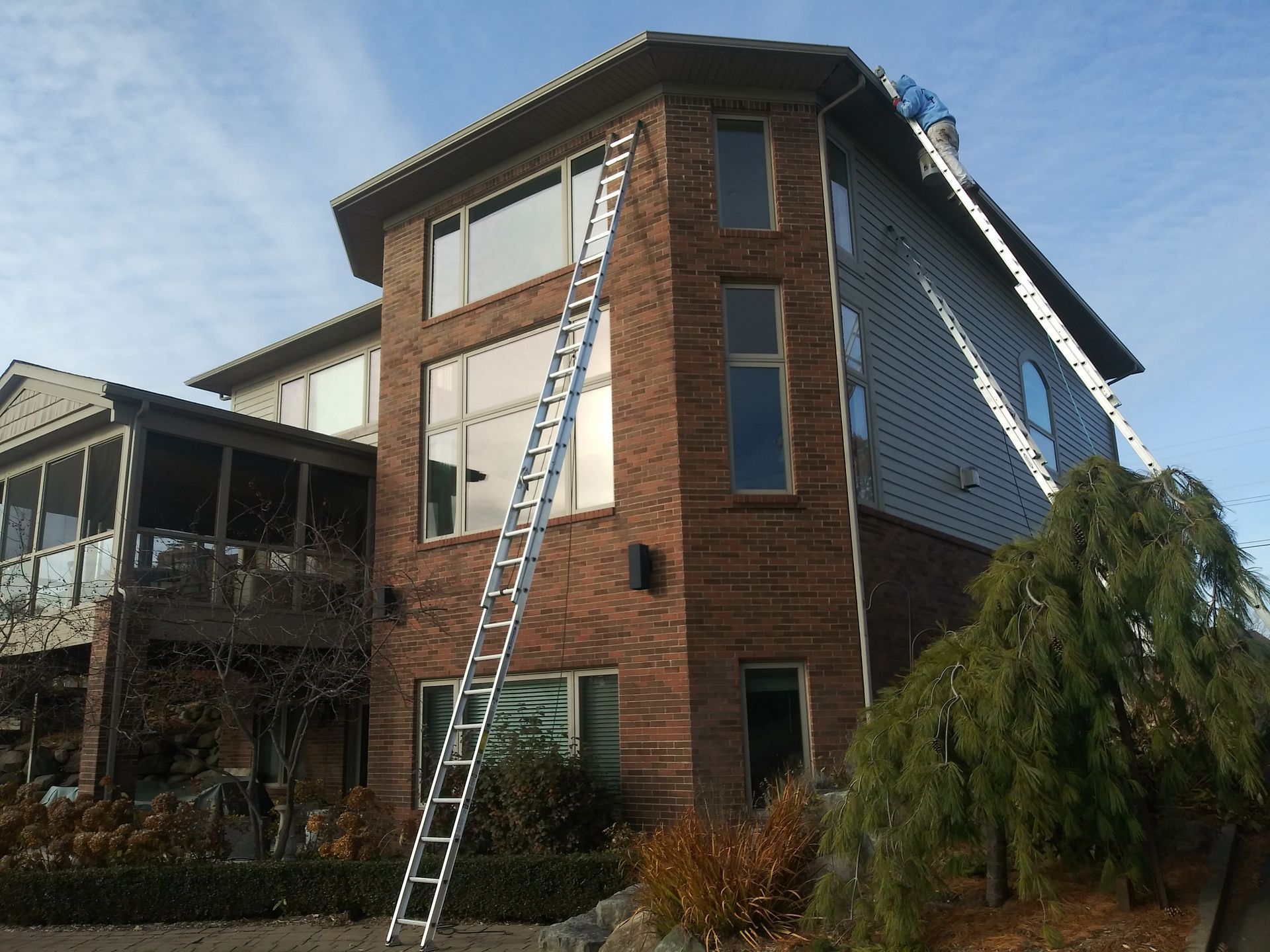 A large brick house with a ladder on the side of it
