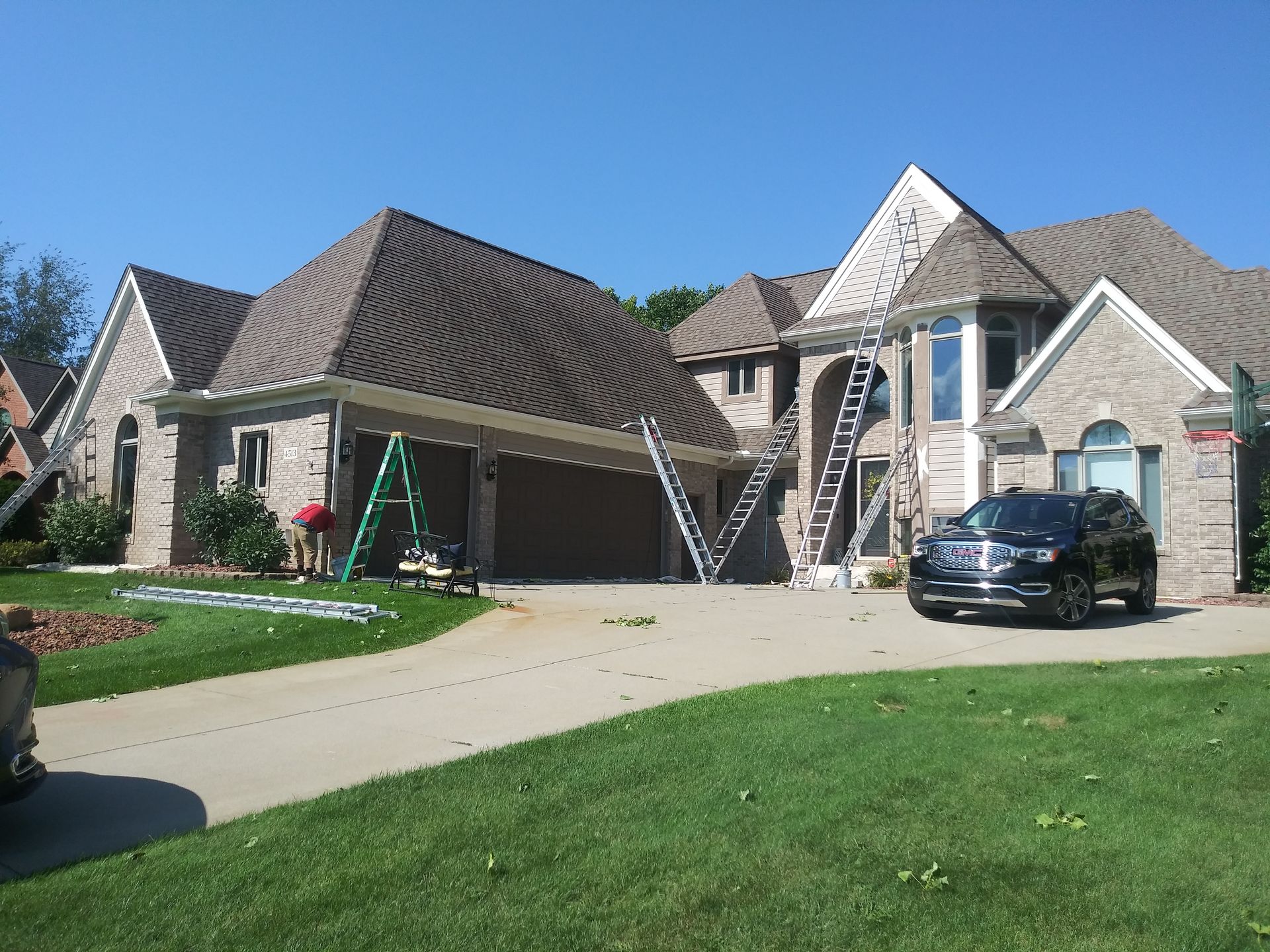 A large house with a car parked in front of it