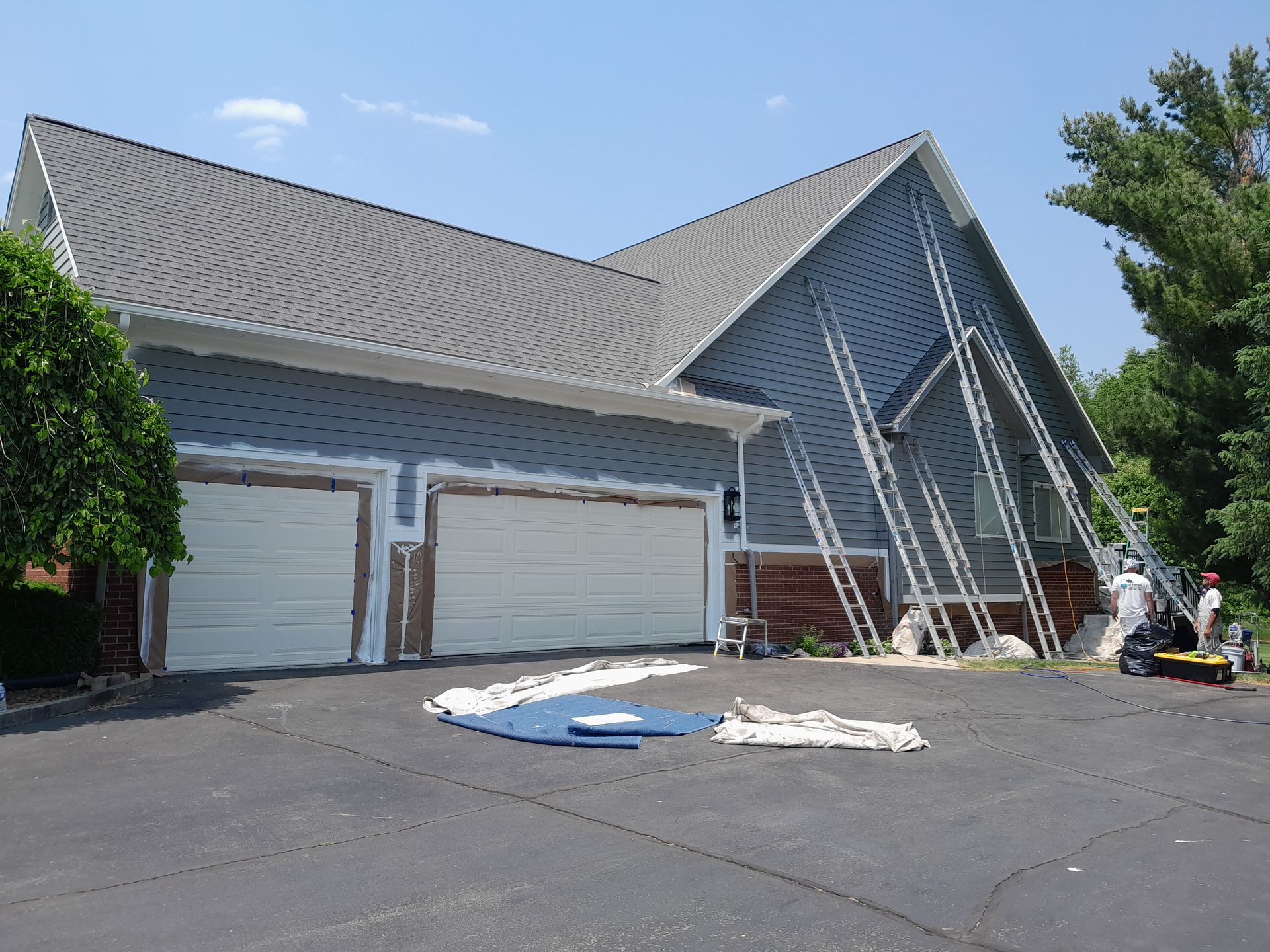 A house is being painted with a lot of scaffolding around it