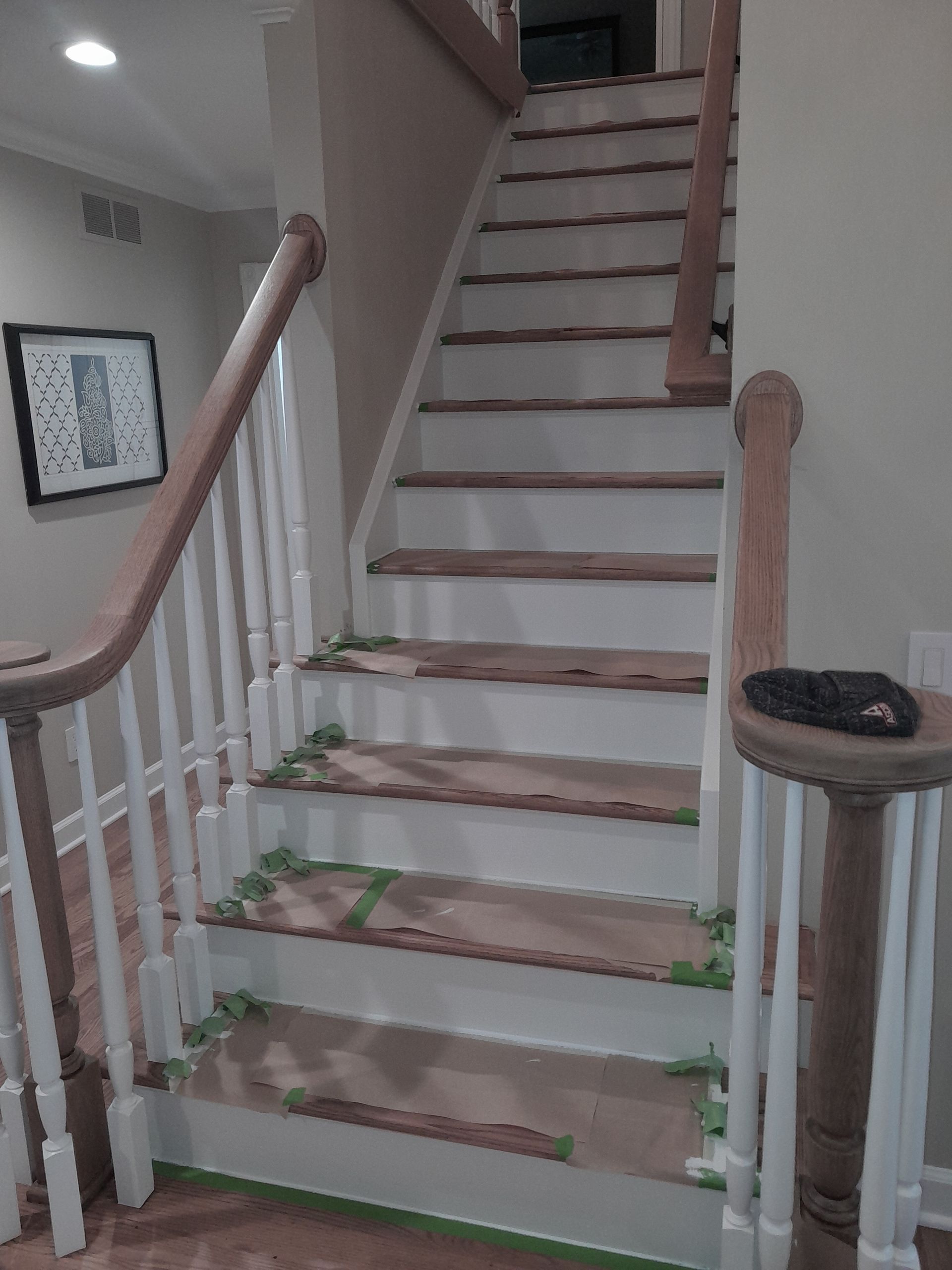 The stairs are painted white and the railing is wooden.
