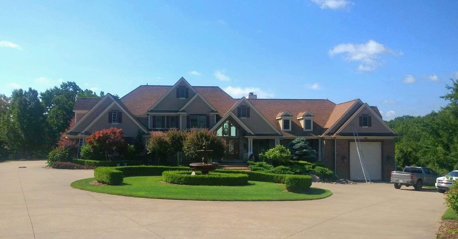 A large house with a circular driveway in front of it