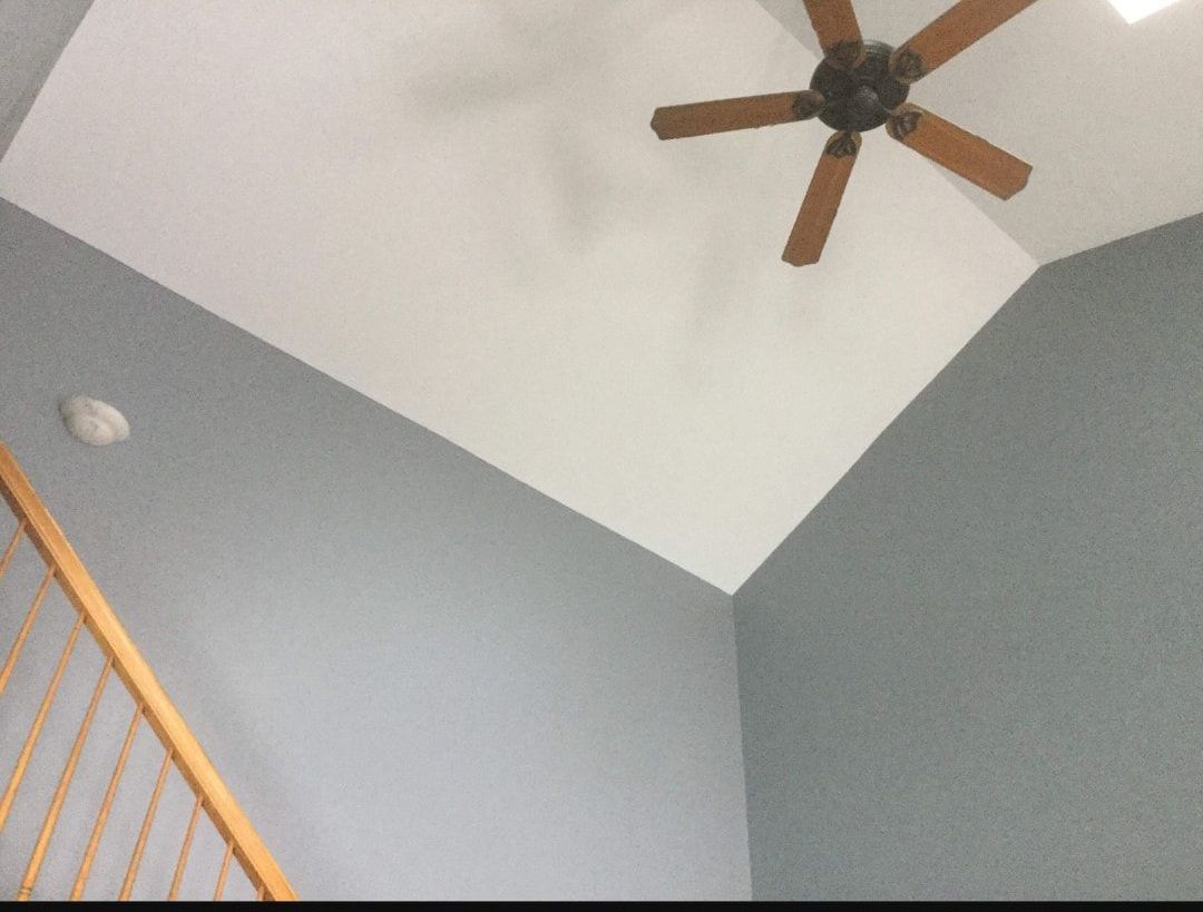 A ceiling fan is hanging from the ceiling of a room