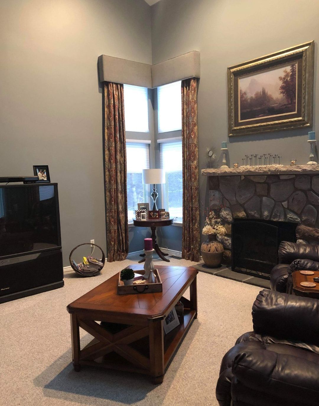 A living room with a fireplace and a coffee table