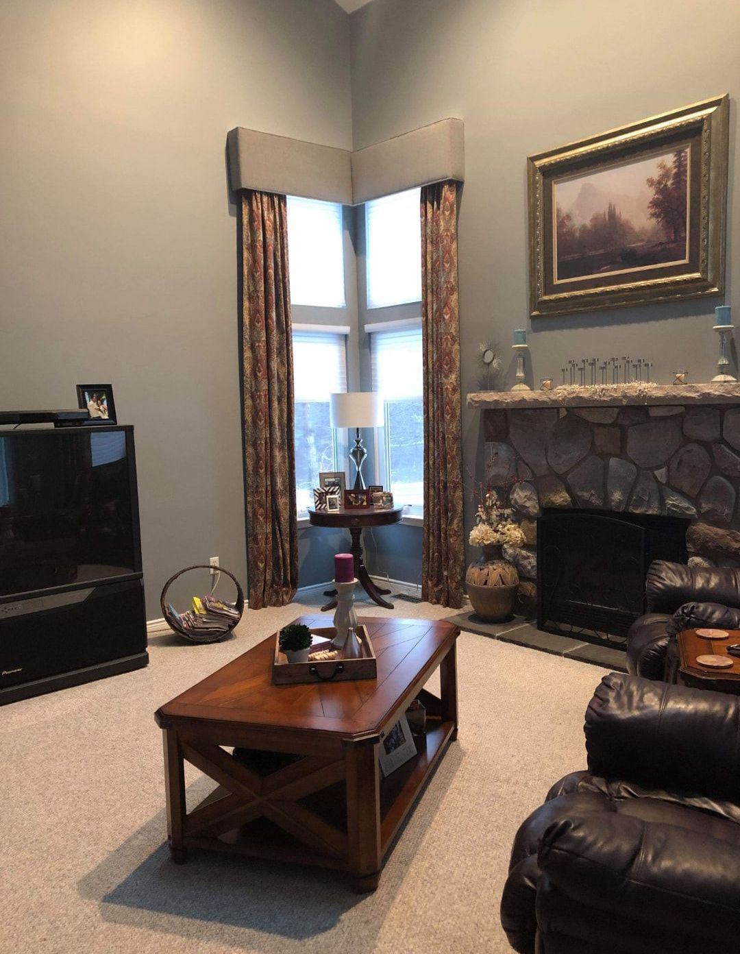 A living room with a fireplace and a coffee table