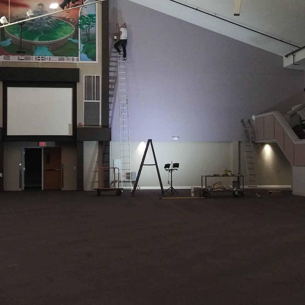 A large room with a ladder and a sign that says a on it