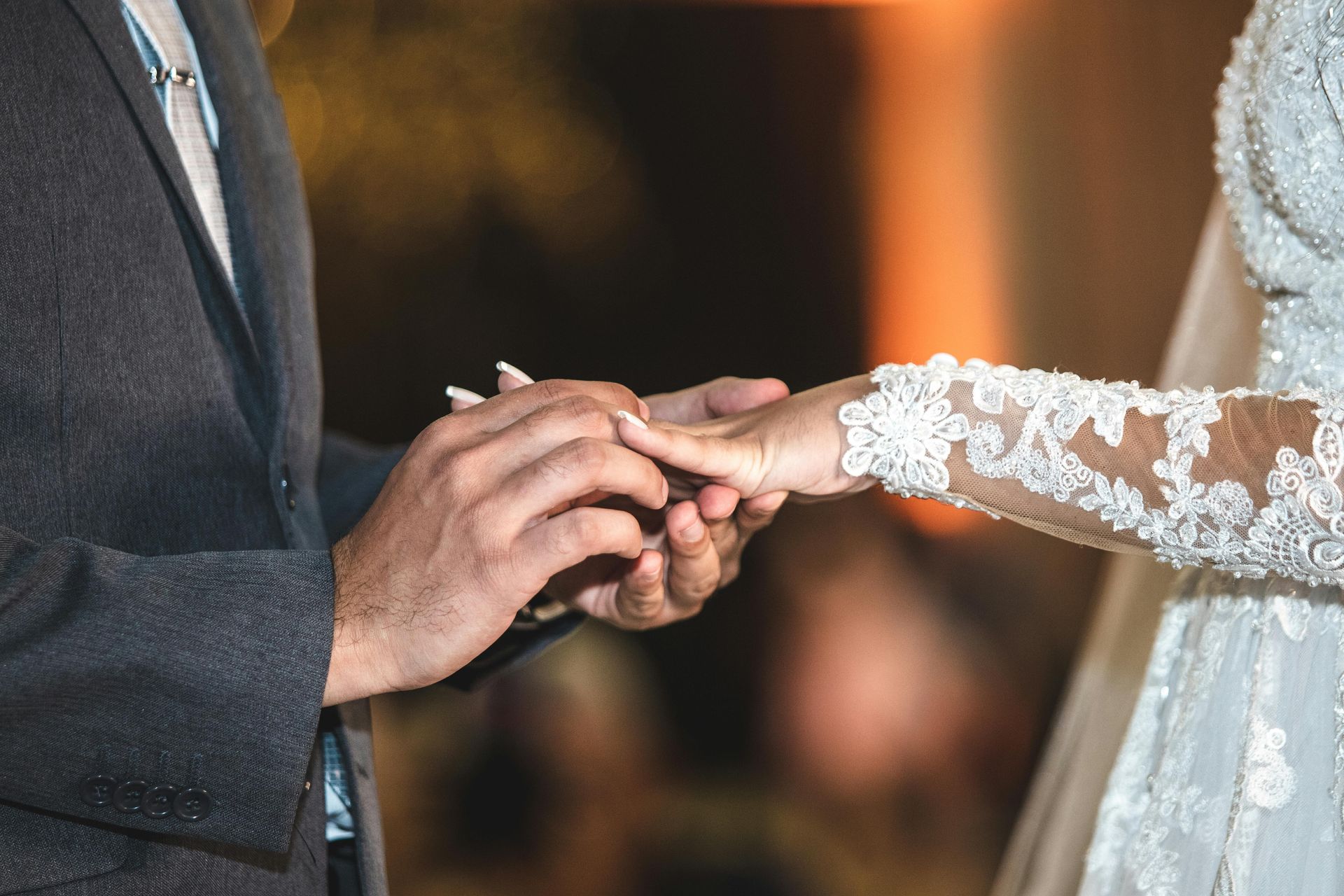 Bride and groom holding hands during a wedding ring exchange