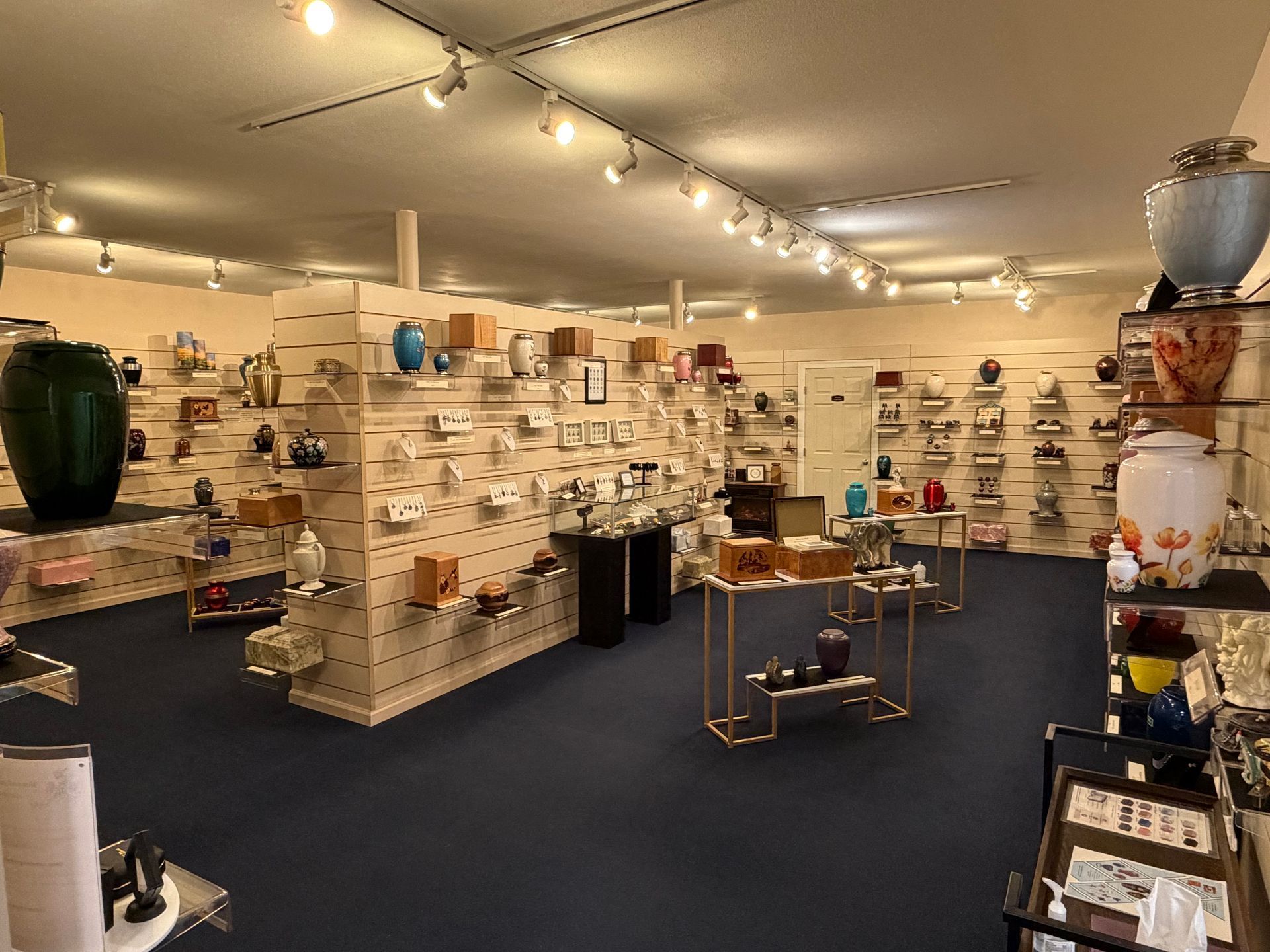 the sun is setting behind a large rock in the ocean