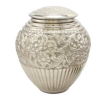 a white vase with a gold stripe on the side is sitting on a white surface .