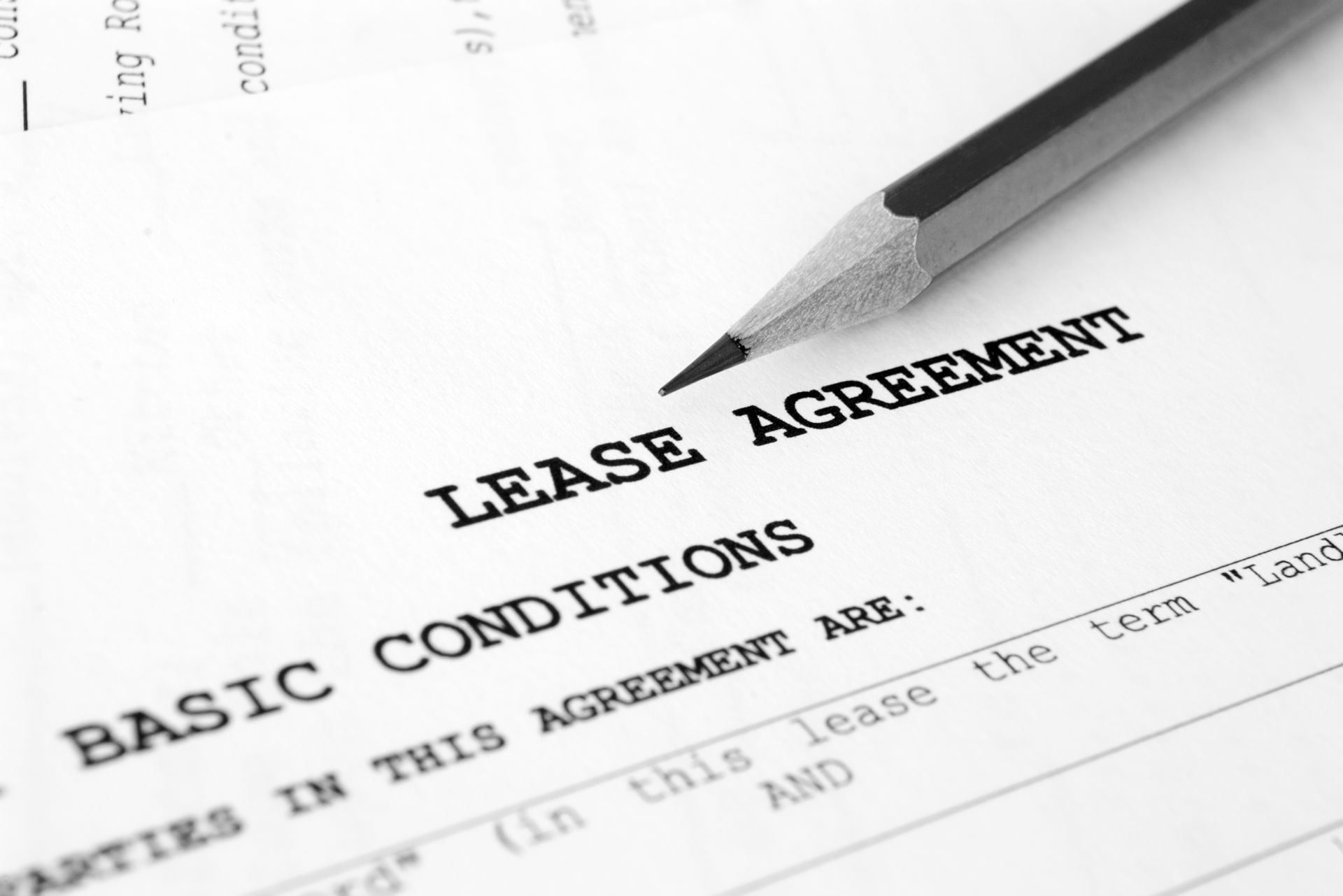 Lease agreement document with a pencil resting on top.