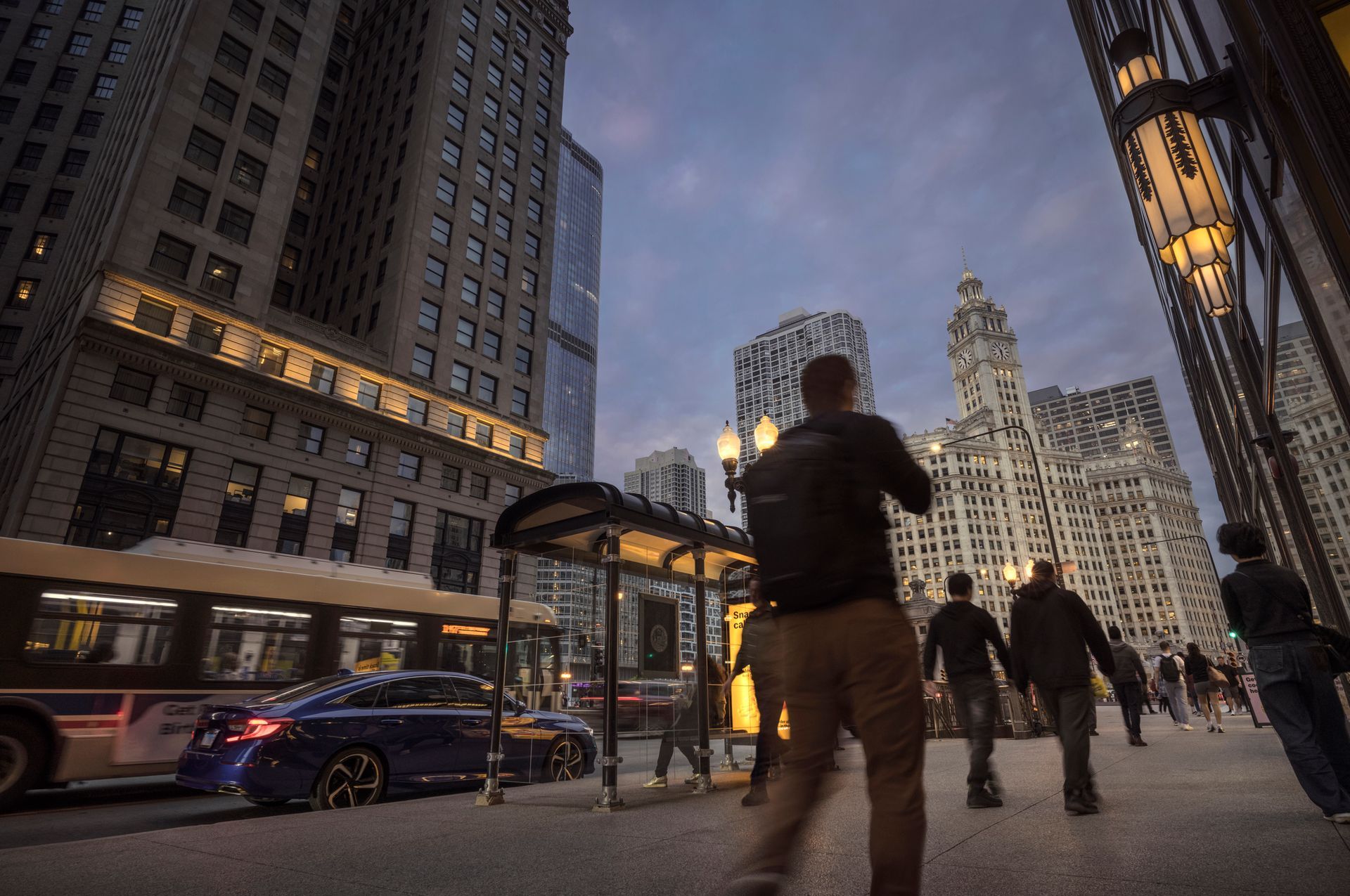 Two people in business attire shake hands over a document, gavel in foreground.