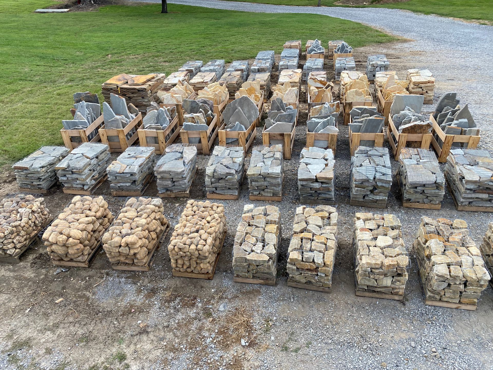 A pile of rocks sitting on top of a gravel road.
