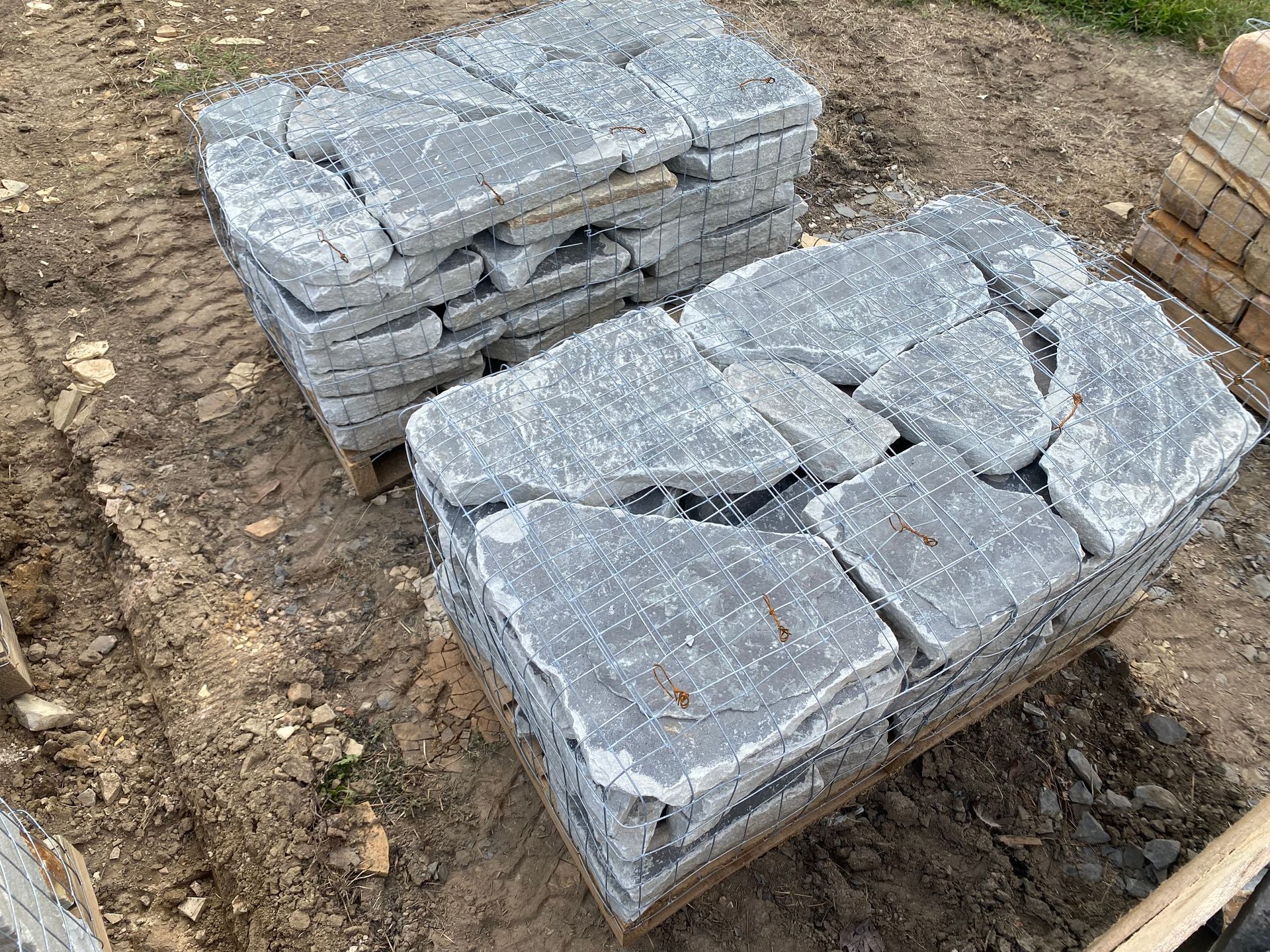 A pile of bricks is sitting on top of a wooden pallet.