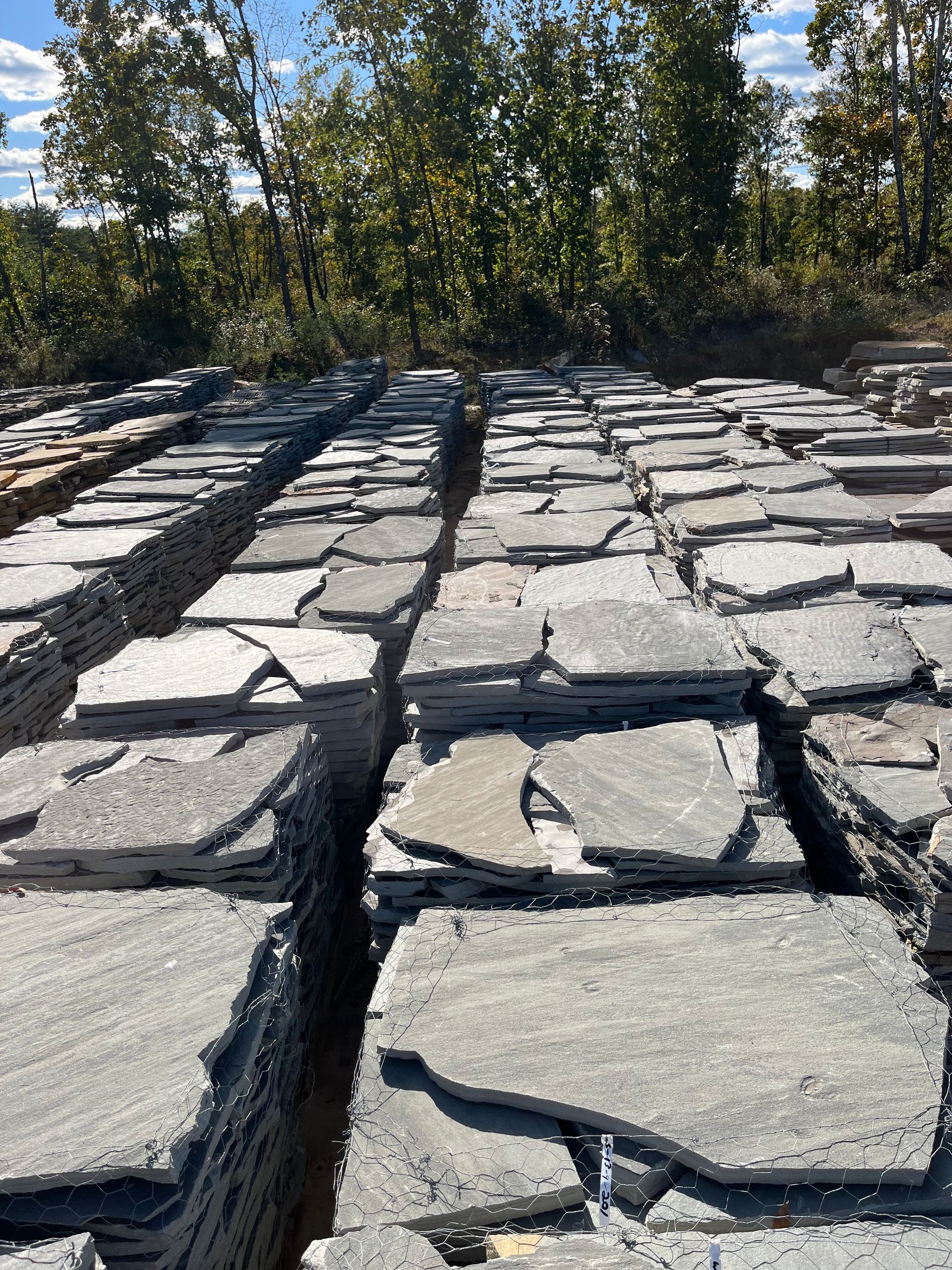 A pile of rocks sitting on top of each other in a field.