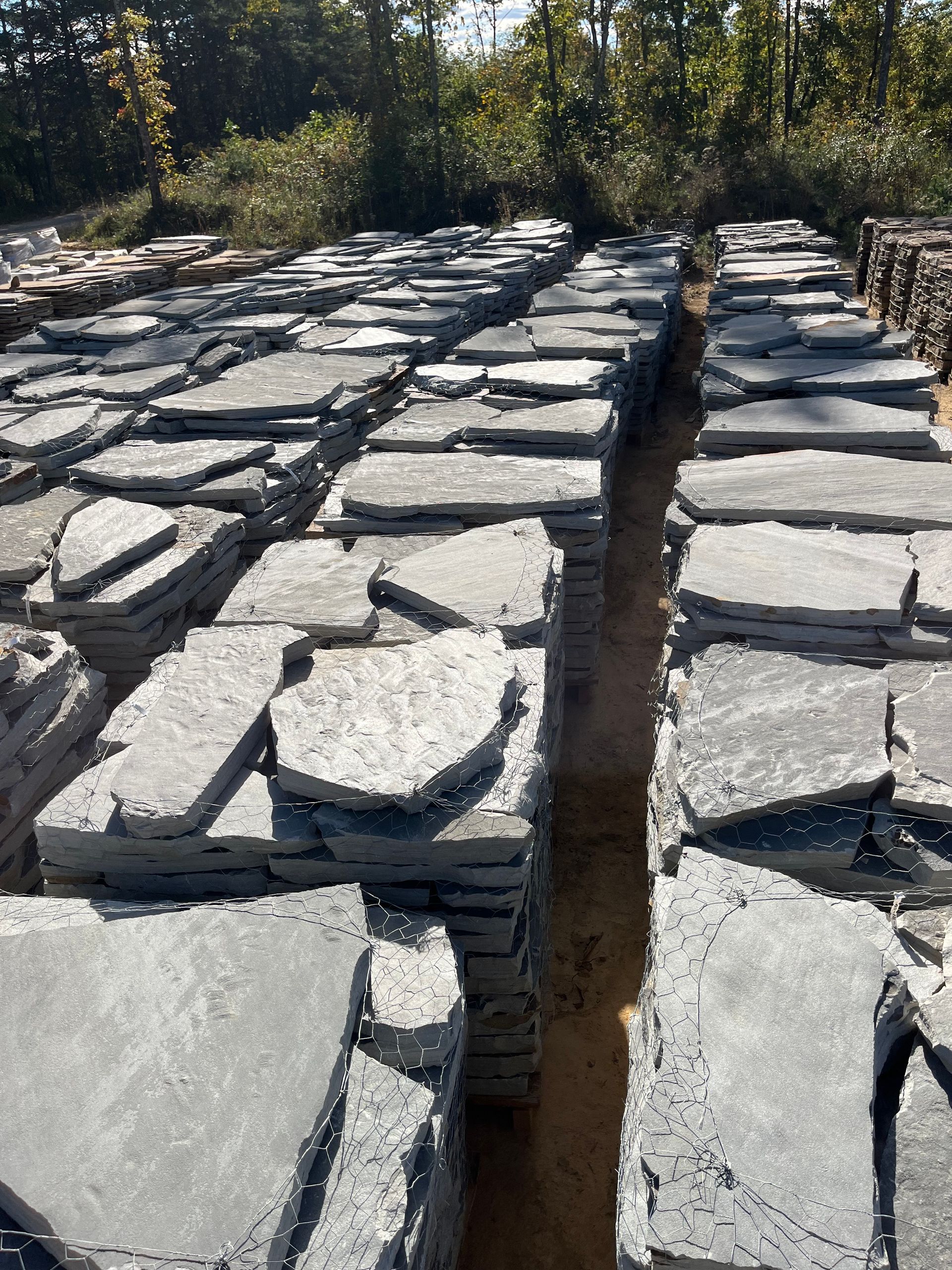 A large pile of rocks stacked on top of each other in a field.