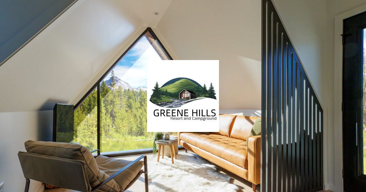 A welcome to greene hills camp sign is in the middle of a grassy field.