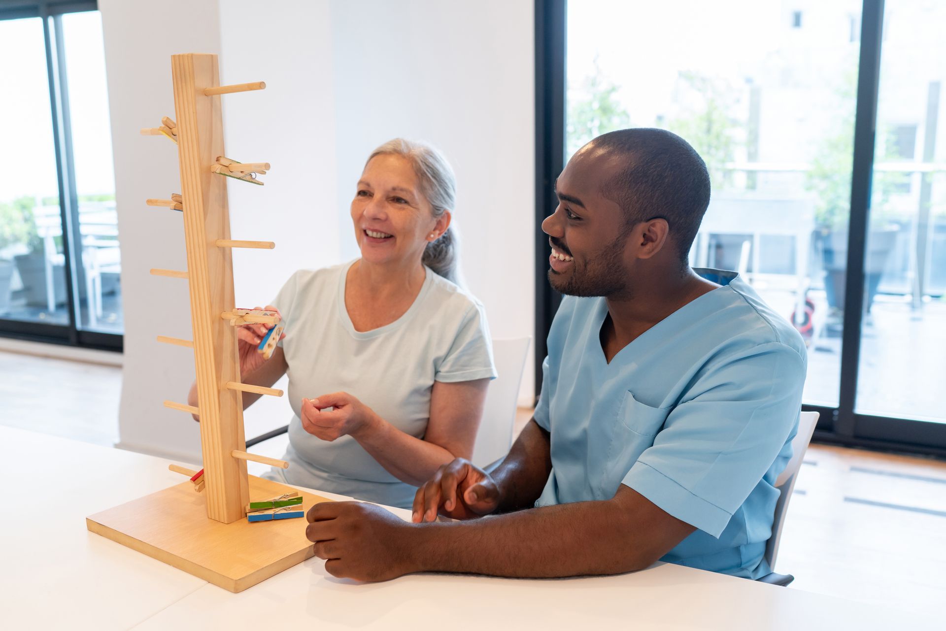 A man and a woman are sitting at a table playing a game.