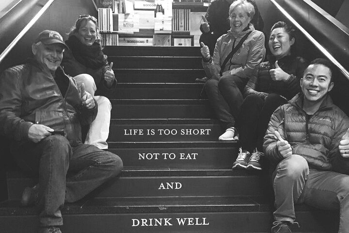 A group of people are sitting on a set of stairs.