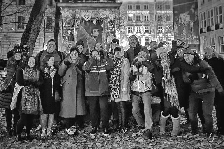 A group of people are posing for a picture in a black and white photo.