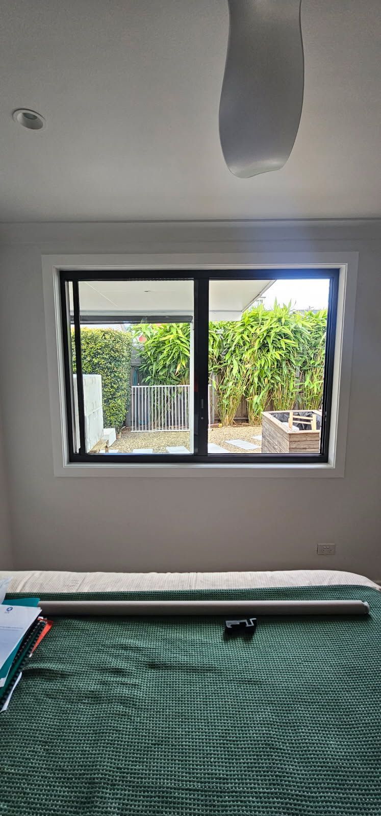 A bedroom with a large window and a pool table.