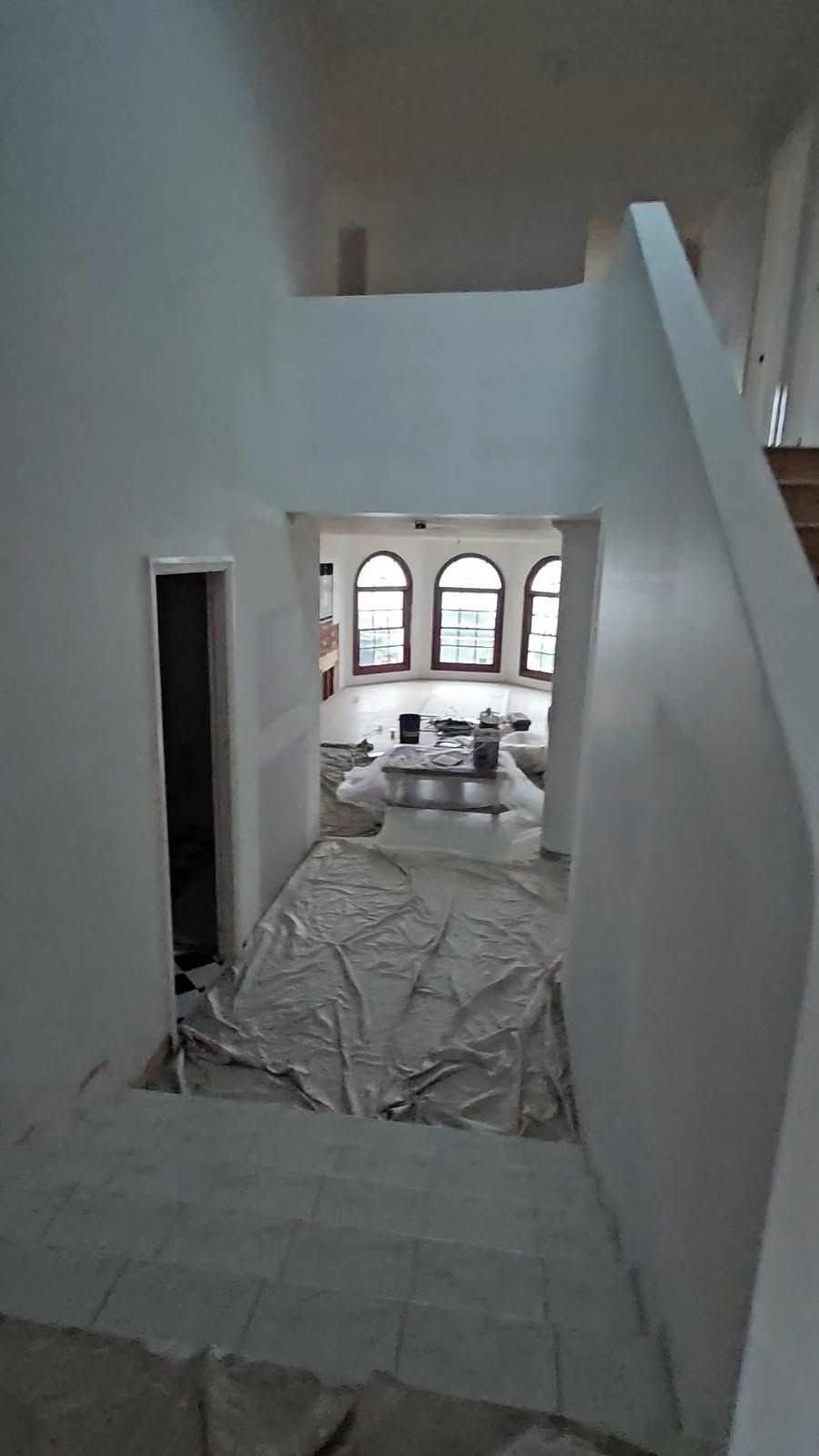A staircase leading up to a living room in a house.