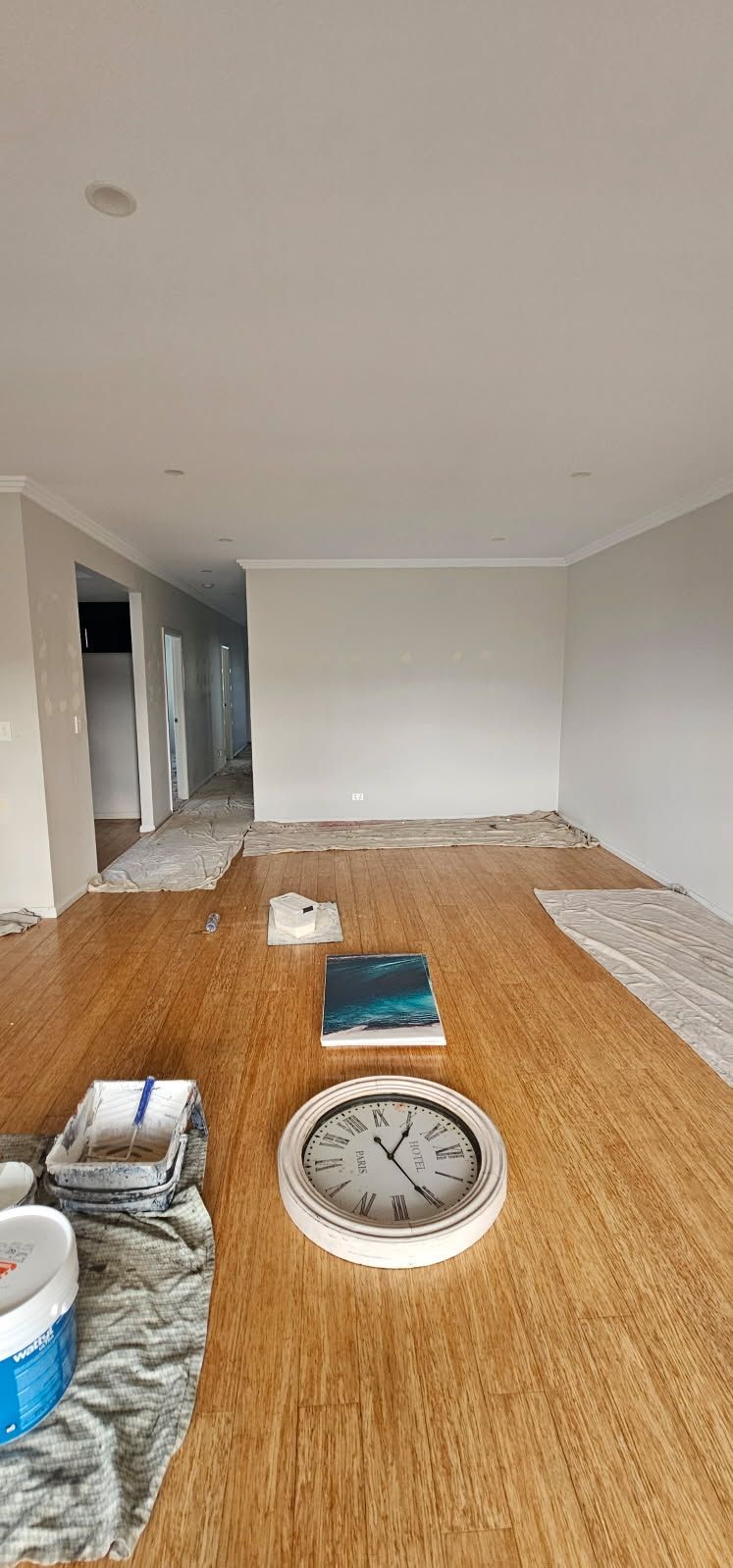 There is a clock on the floor in the middle of the room.