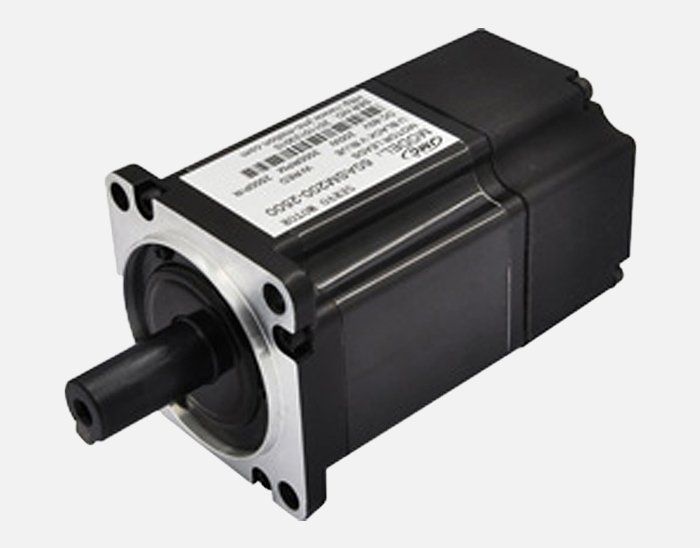 A small black motor with a white label on it. Drives and Motors