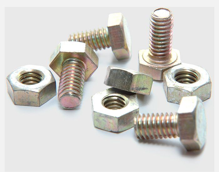 A bunch of nuts and bolts on a white surface