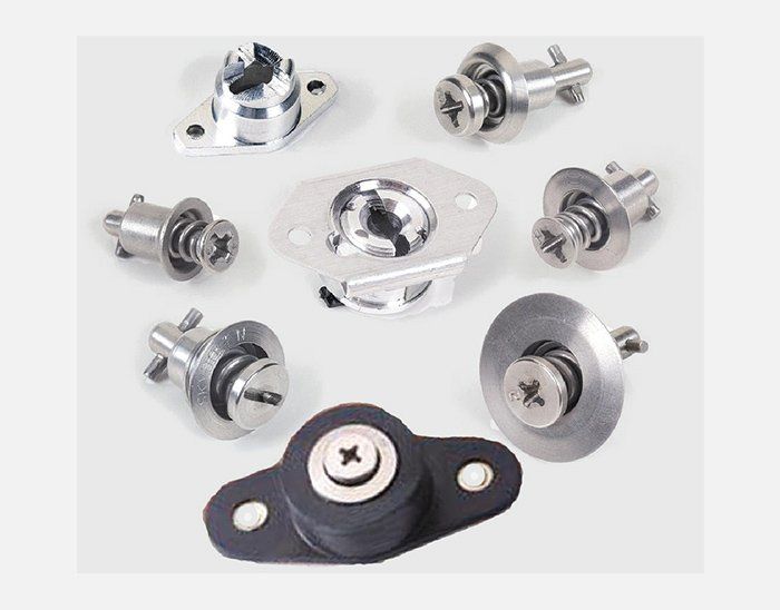 There are many different types of screws and nuts on the table.