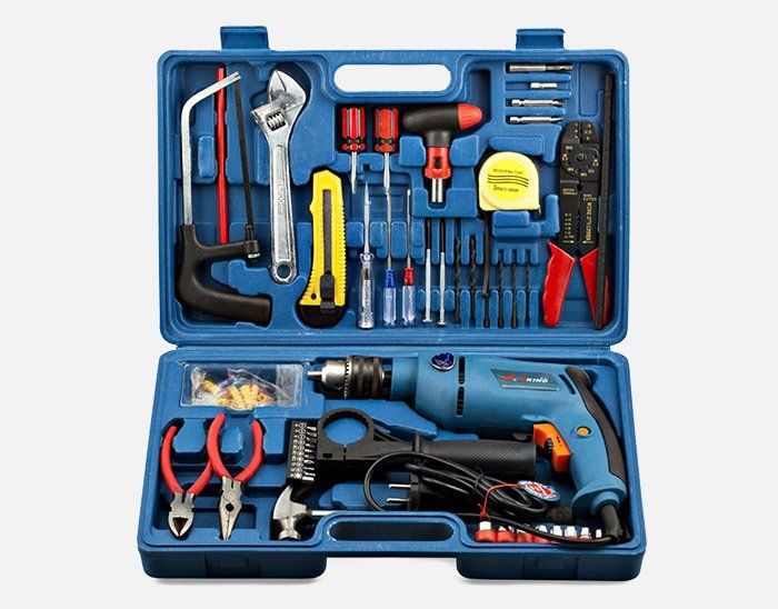 A blue toolbox filled with a drill , pliers , and other tools.