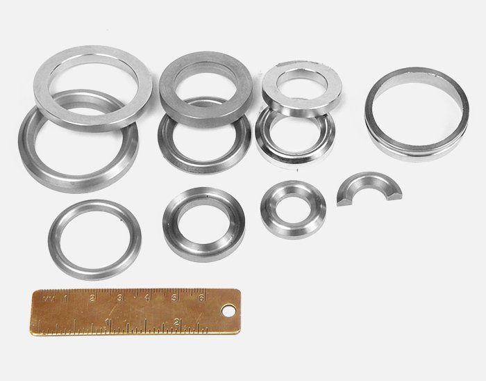 A ruler is next to a bunch of metal rings.