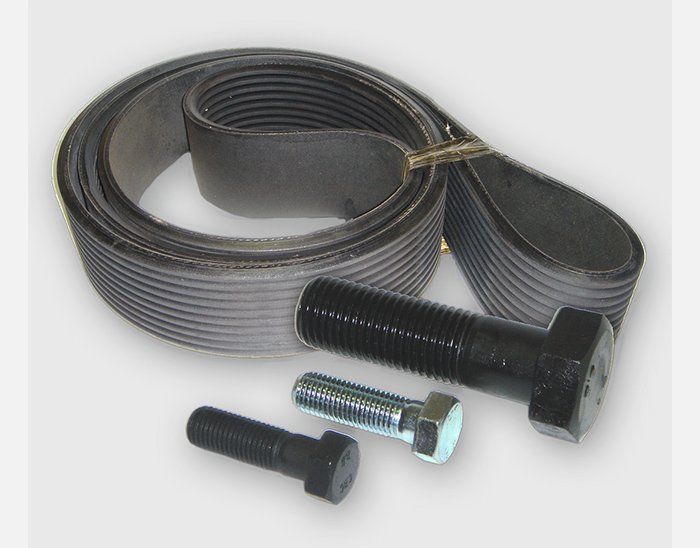 A belt and two screws on a white surface