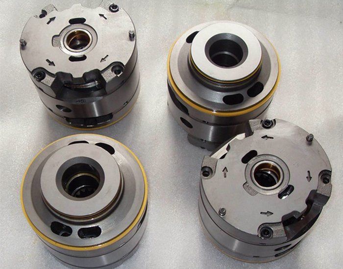 Four metal cylinders are sitting on a white surface