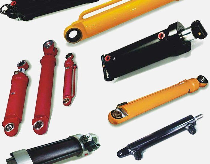 A bunch of different types of hydraulic cylinders on a white background