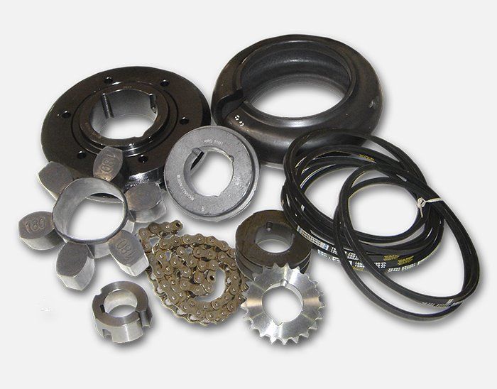 A bunch of gears and belts on a white background. Power Transmission