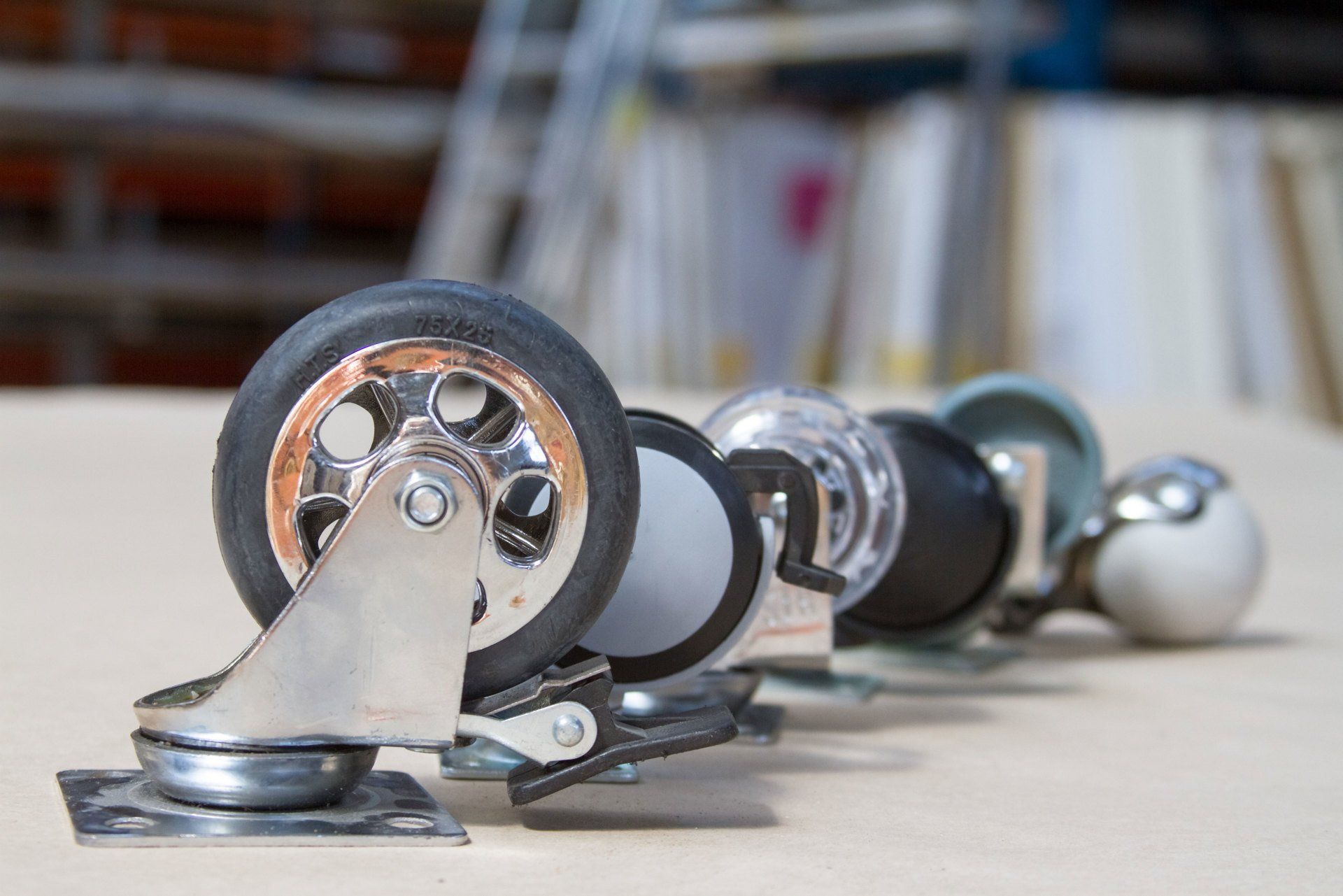 A row of casters are lined up on a table.