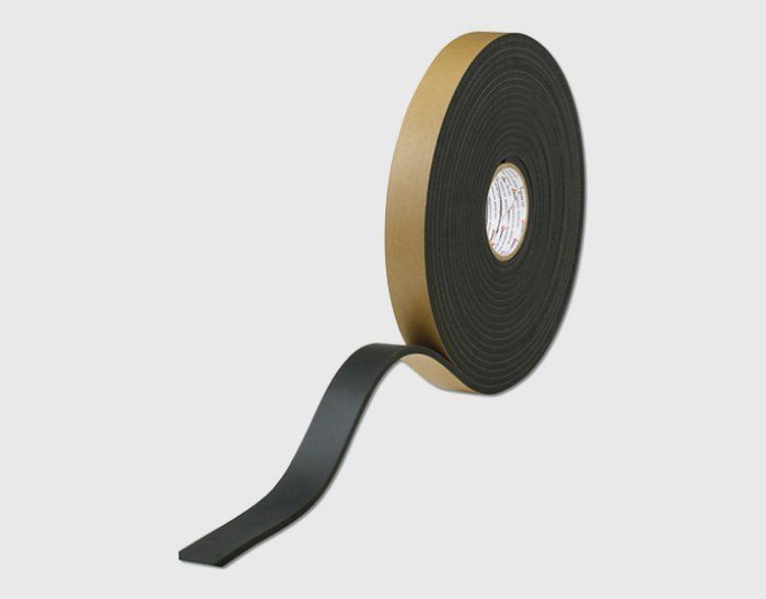 A roll of black foam tape on a white background.