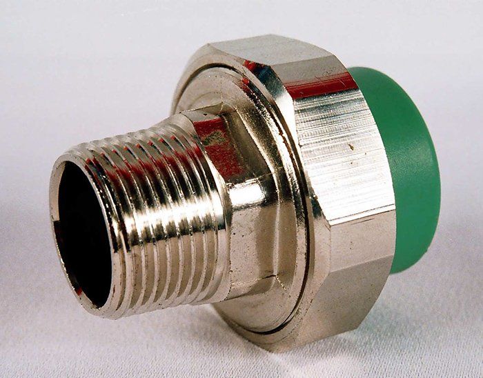 A brass pipe fitting with a green plastic insert