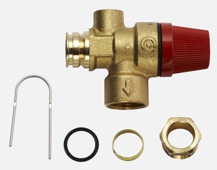 A close up of a brass valve with nuts and washers on a white background.