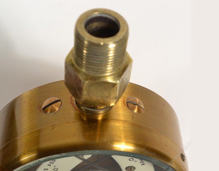 A close up of a brass object with a hole in it