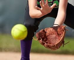 Softball player catching a neon yellow ball with a brown glove. Purple sock and black pants.