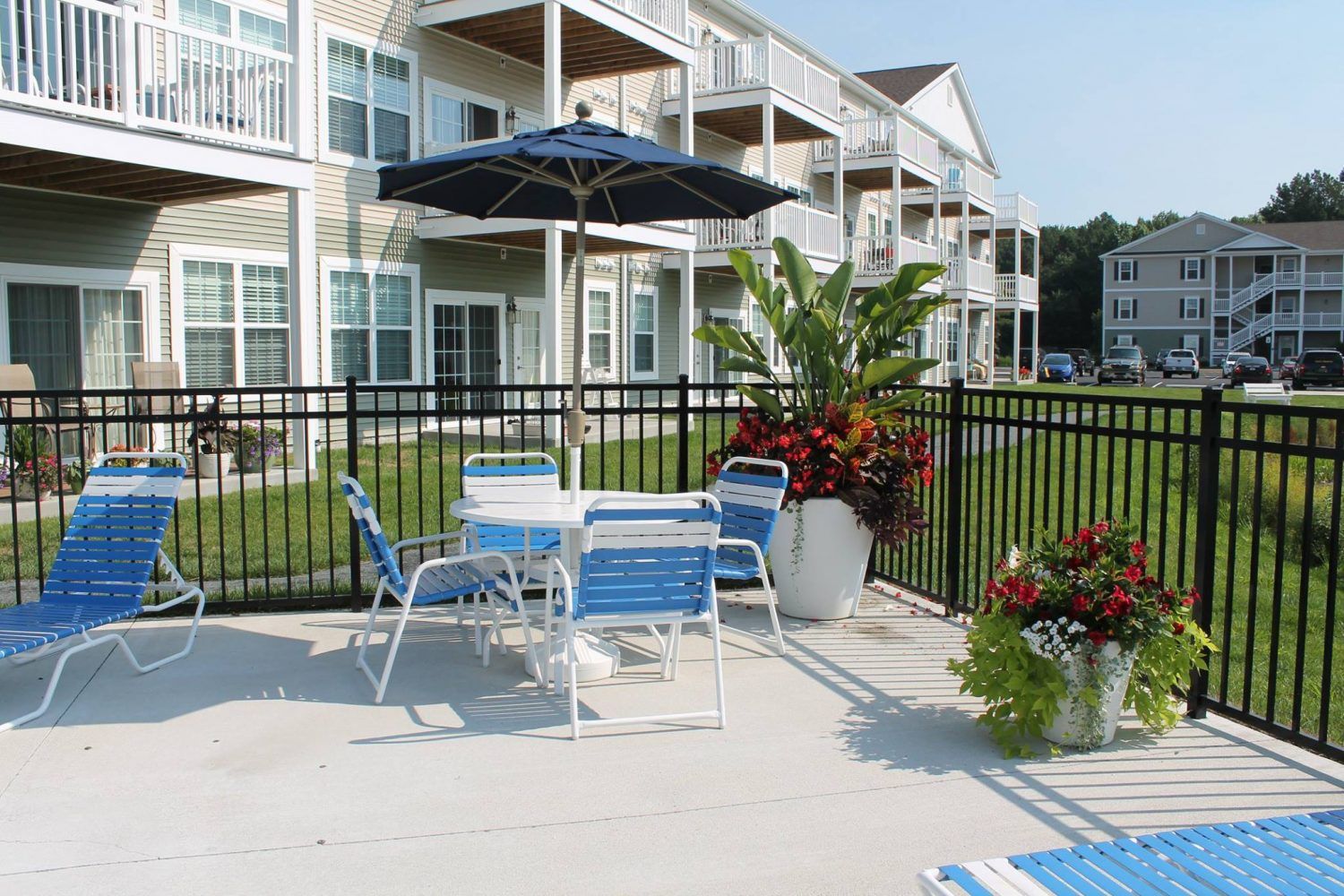 Sun covered, poolside seating at Beach Plum Dunes