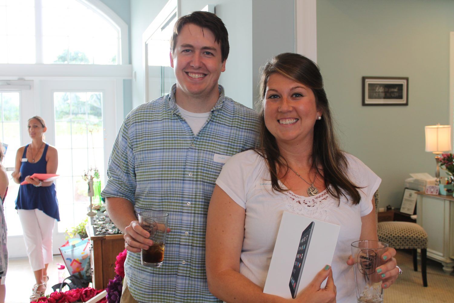Couple holding a new ipad and smiling