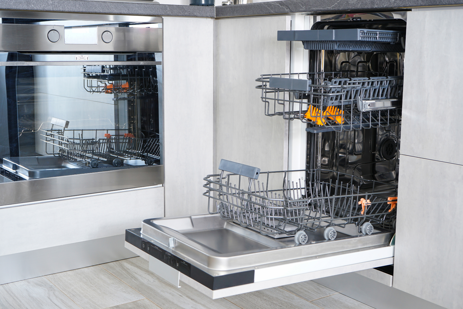 A dishwasher is open in a kitchen with the door open.