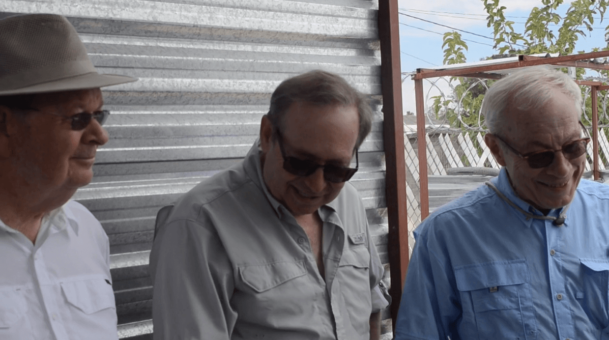 Jim Culver, Andre St Mitchel and Terry Martell  are standing next to each other in front of a metal wall.