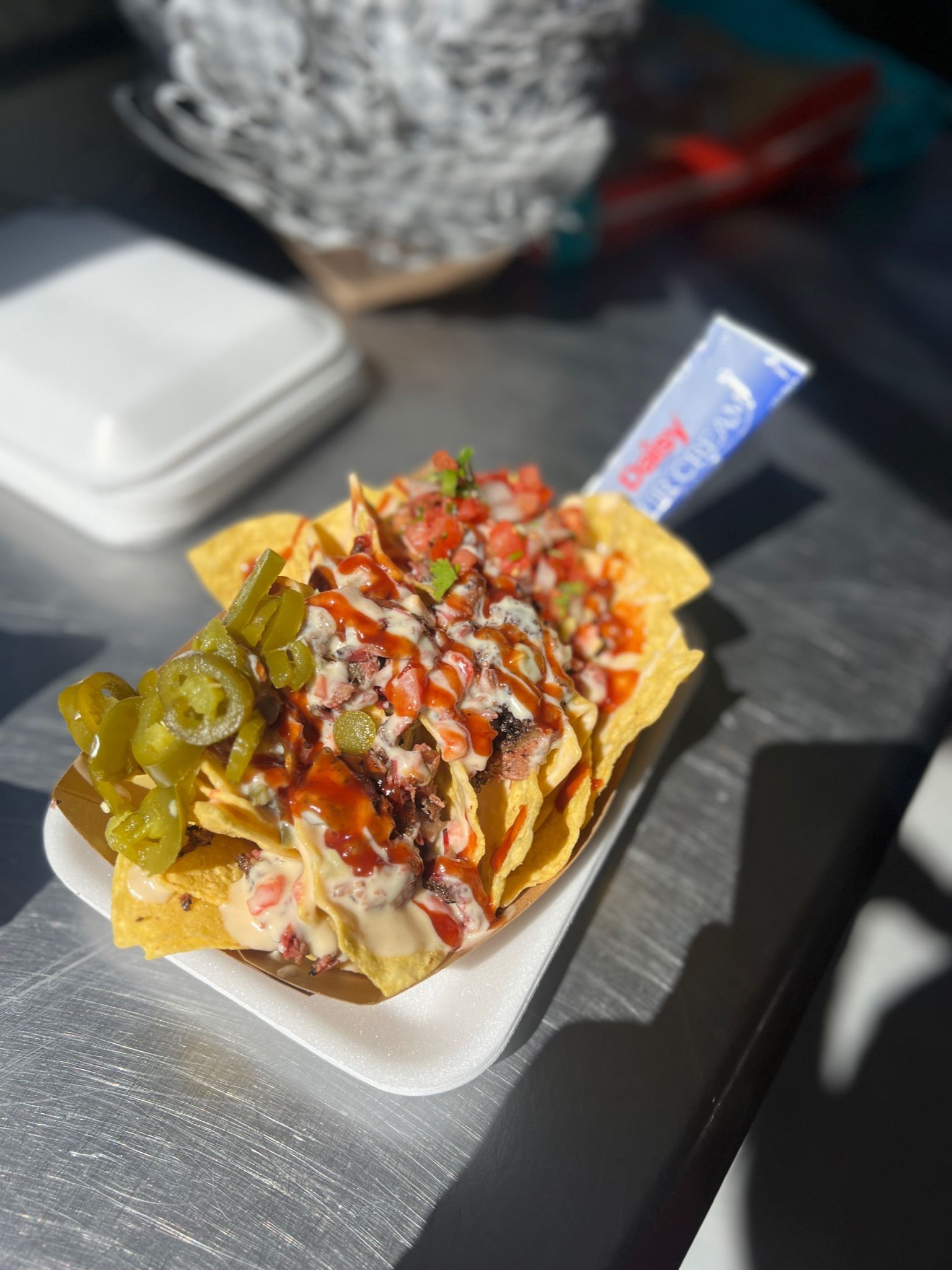 A close up of a plate of nachos on a table
