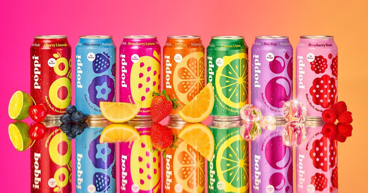 A row of colorful cans of soda with fruit on them.