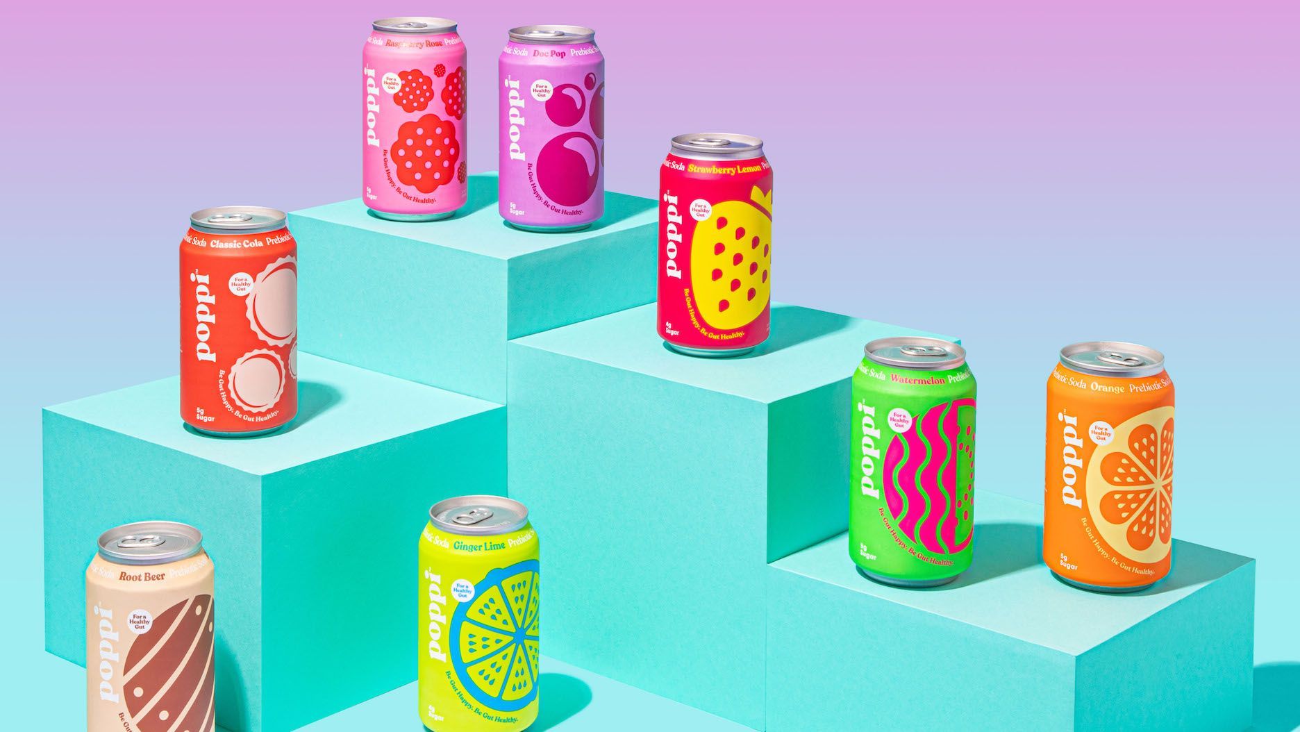 A bunch of cans of soda are sitting on top of a blue cube.