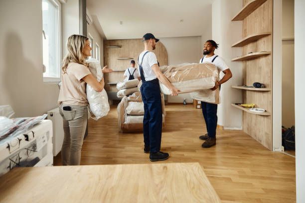 A professional mover lifting furniture in an apartment, showcasing the services of a moving company.