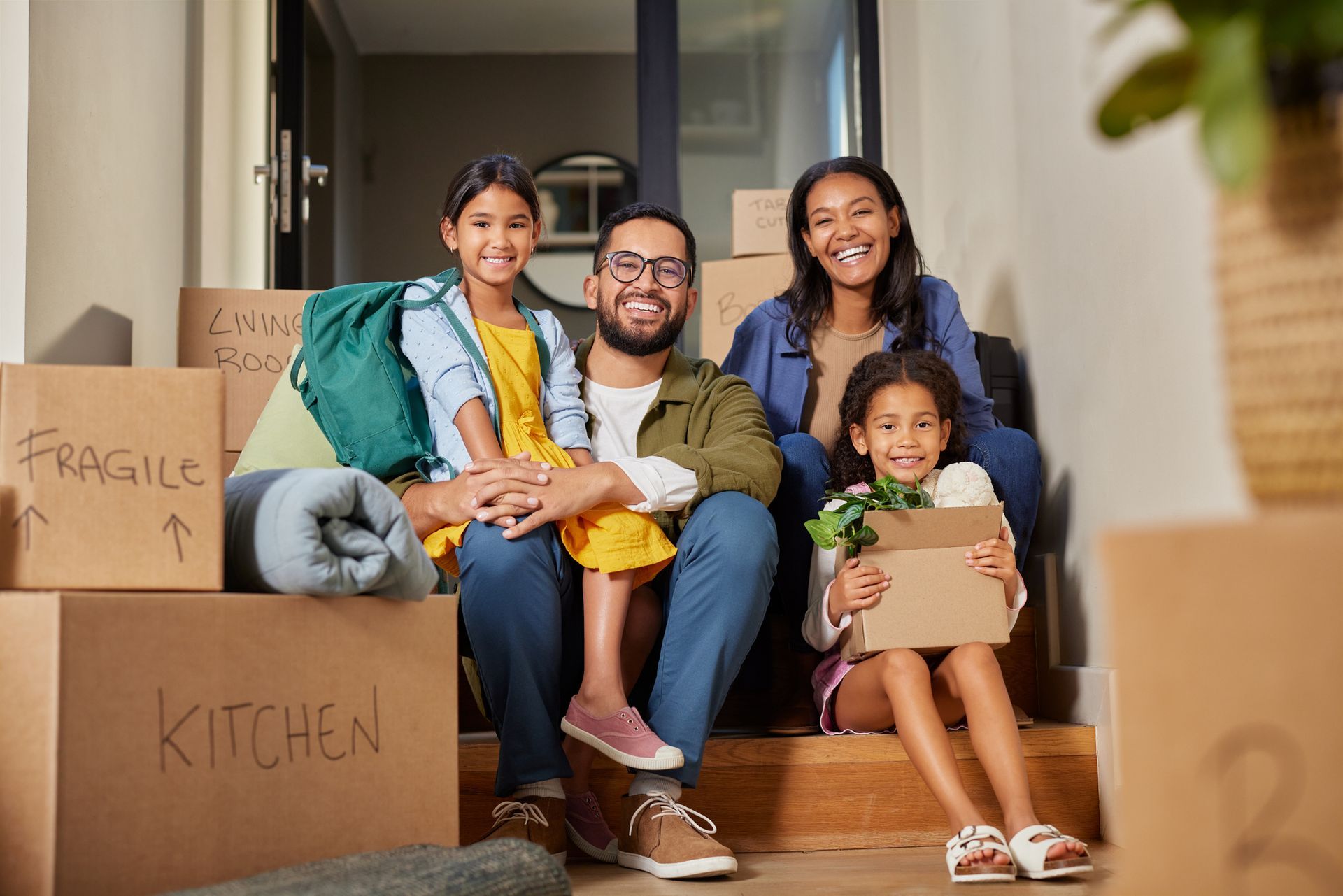 Happy multiethnic family smiling after moving home.