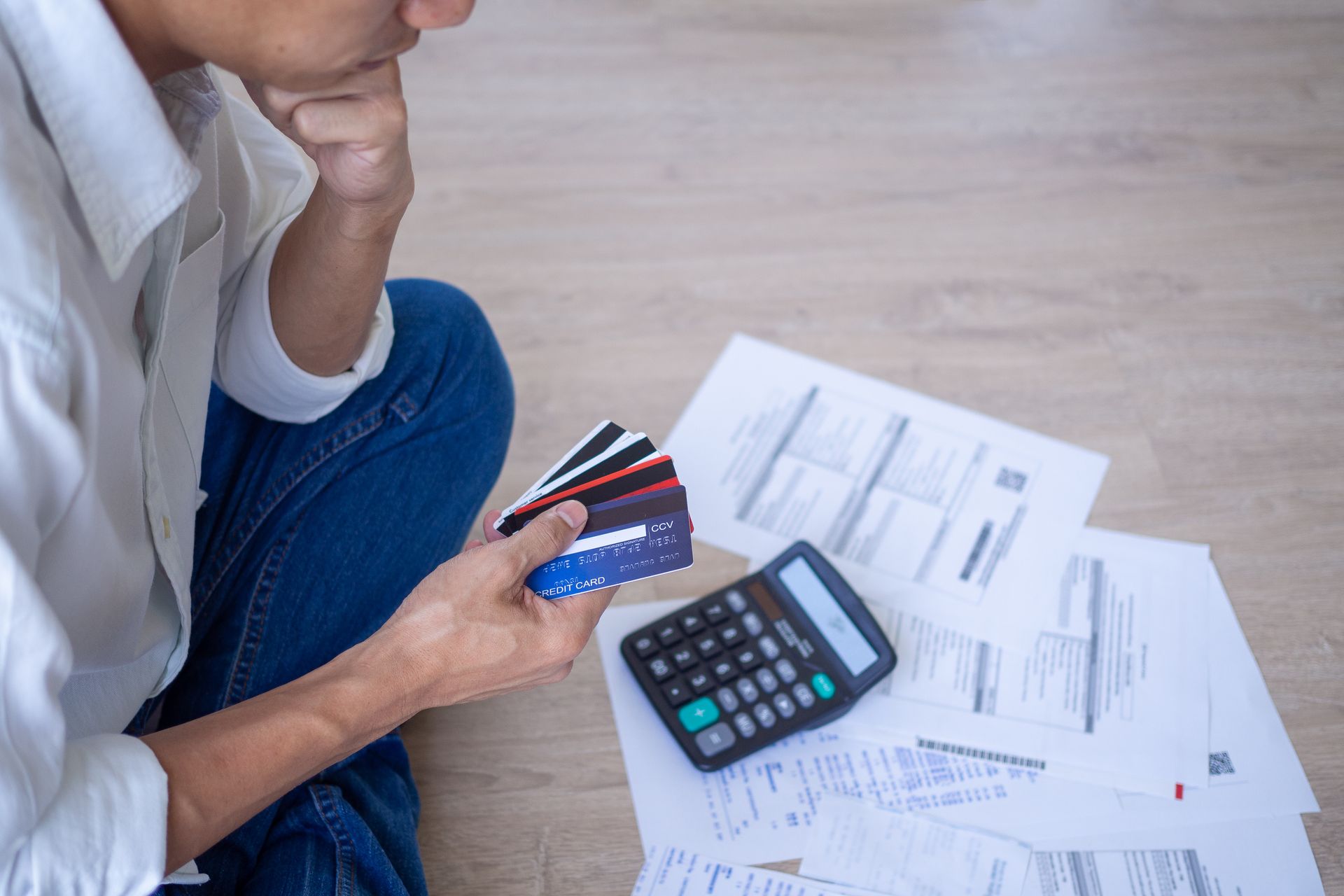 man holding credit cards and looking at his finances